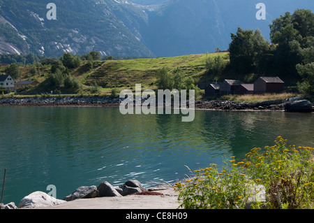 Eidfjord Norway view over water towards boathouses on water`s edge Stock Photo